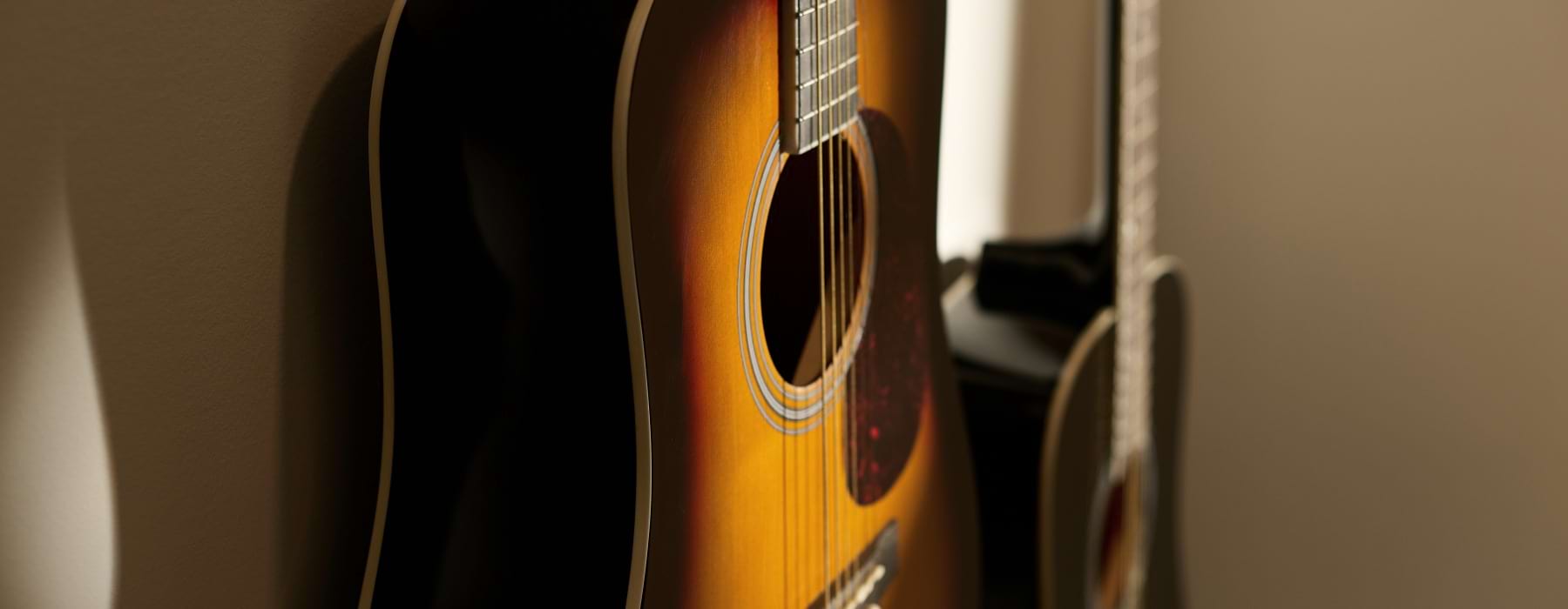two guitars hanging on a wall